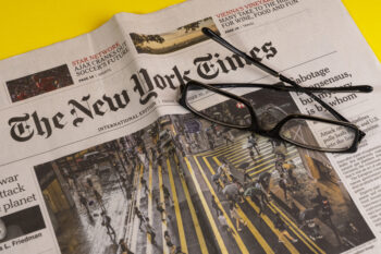 Vienna, Austria. September 2022. a pair of eyeglasses above the New York Times newspaper