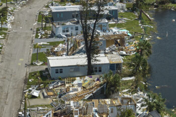 Severely damaged by hurricane Ian houses in Florida mobile home residential area. Consequences of natural disaster.